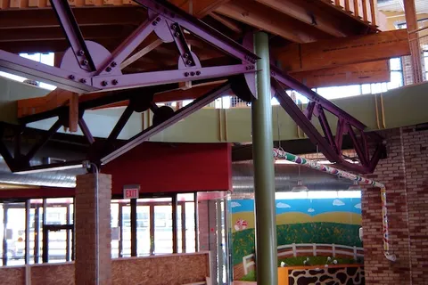 Painted exposed steel trusses and support column inside the Grand Rapids Children's Museum