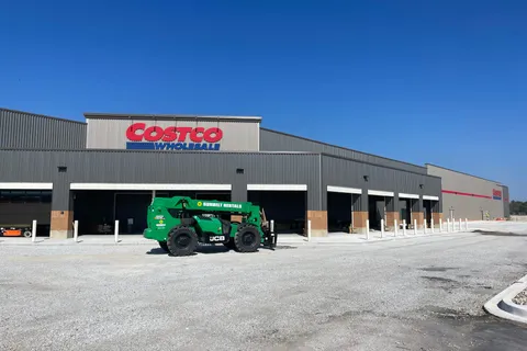 Exterior of a new Costco Wholesale warehouse with a telehandler in the foreground