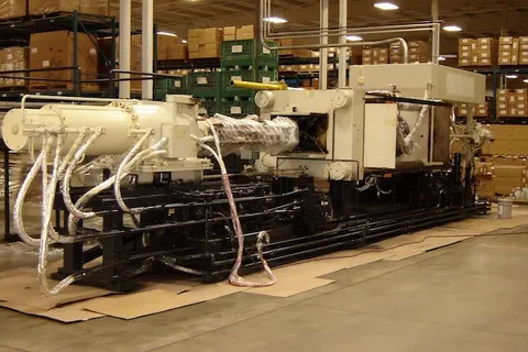 Freshly painted industrial machine on a warehouse production floor