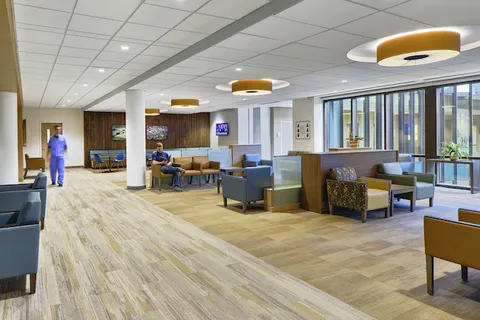 Hospital waiting area with wood-look flooring and lounge seating